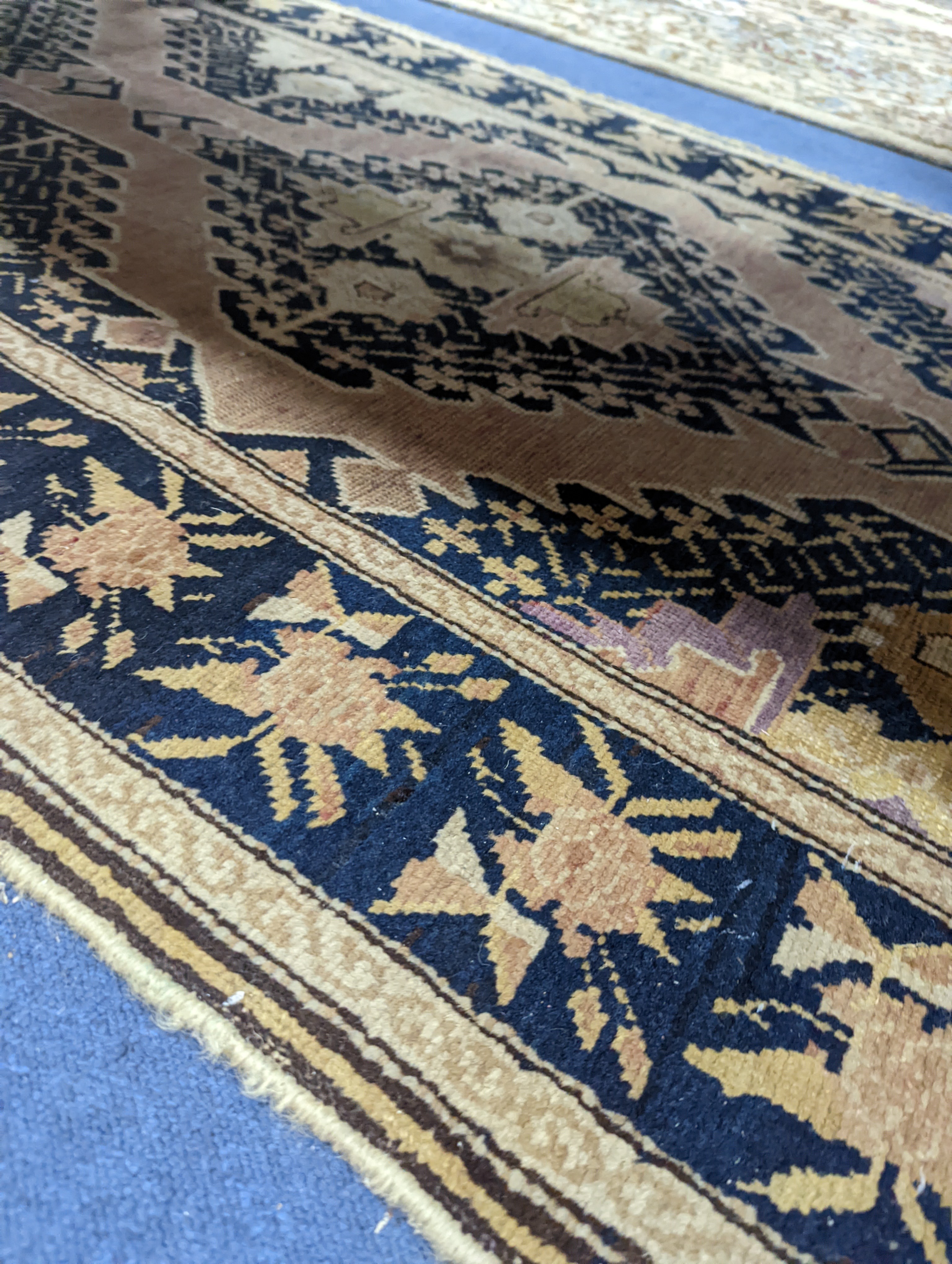 A Caucasian pink ground runner, woven with geometric devices, 483 x 107cm